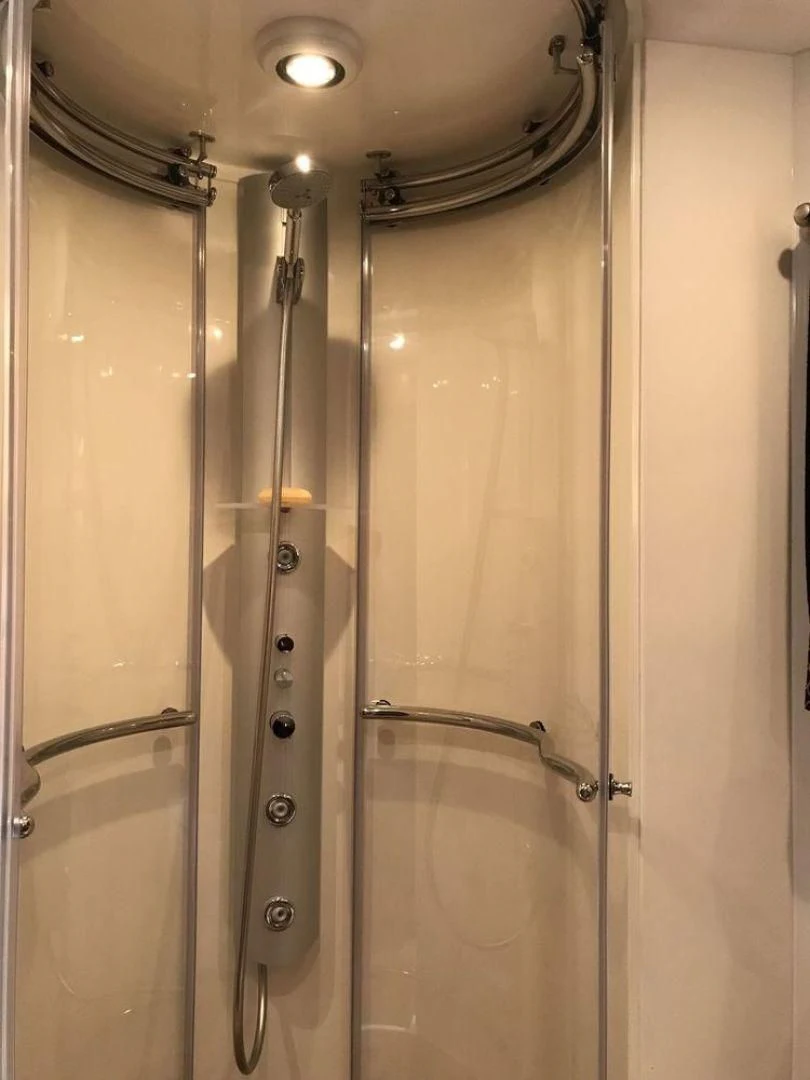 a bathroom with a glass shower aboard DAY DREAMER Yacht for Sale