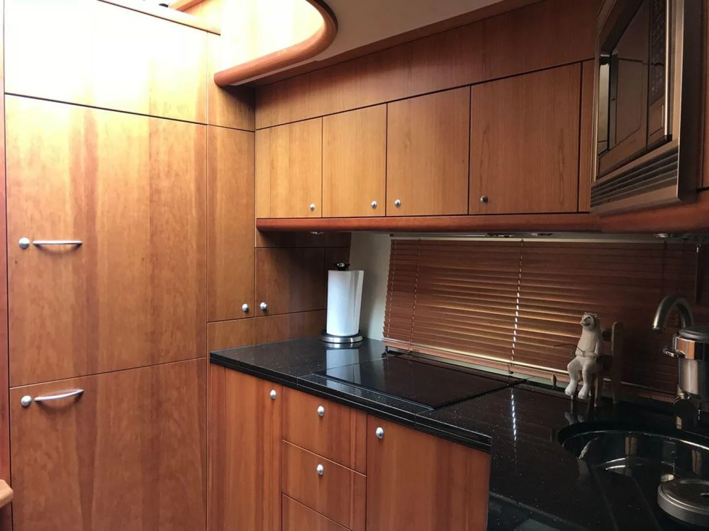a kitchen with wooden cabinets aboard DAY DREAMER Yacht for Sale