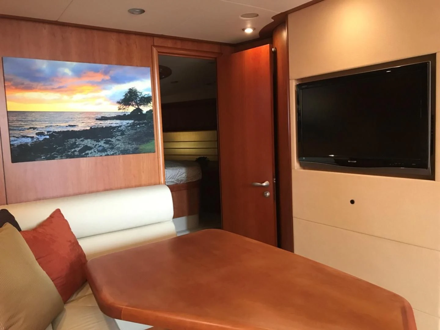 a room with a tv and a table aboard DAY DREAMER Yacht for Sale