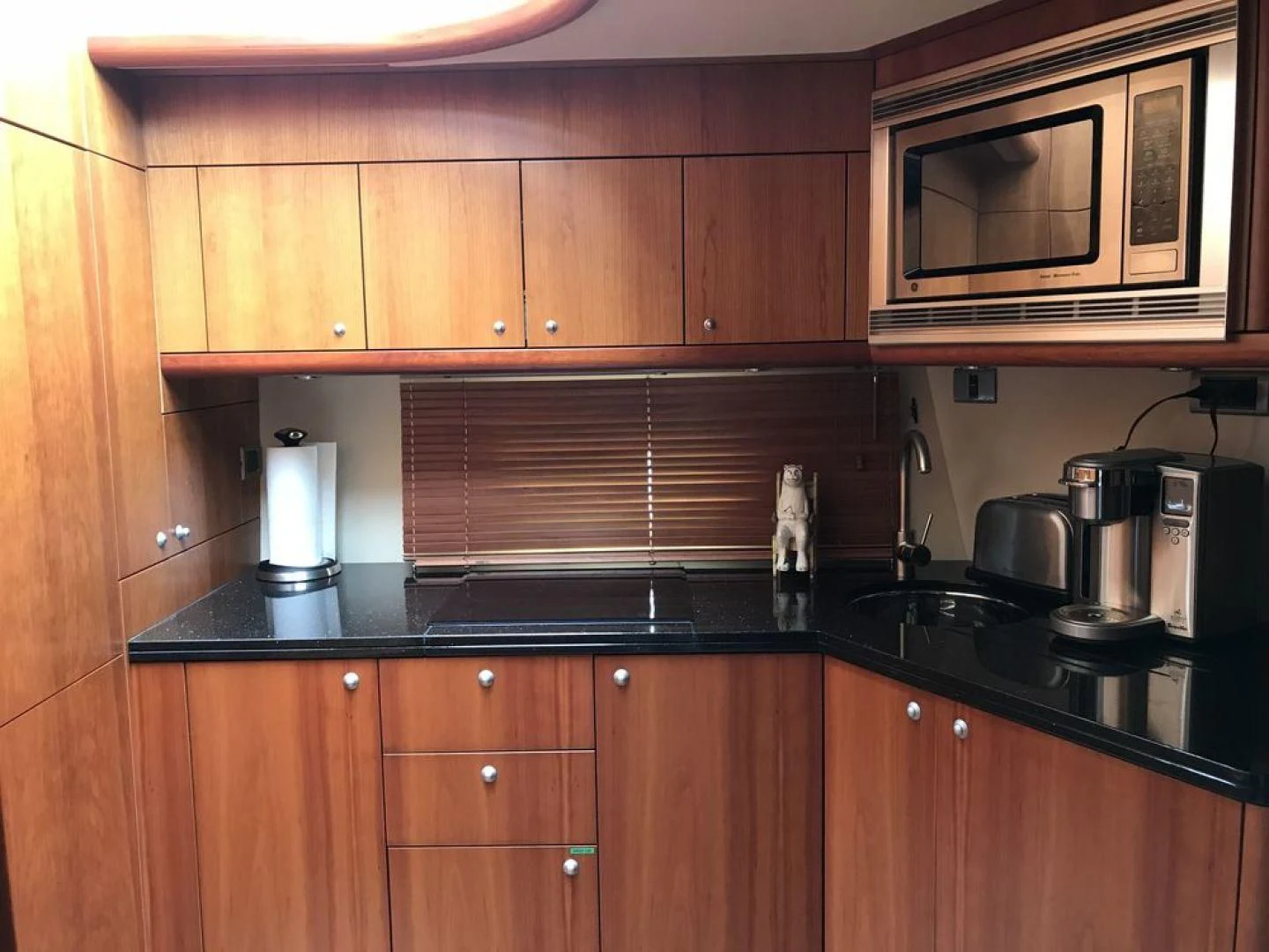 a kitchen with wooden cabinets aboard DAY DREAMER Yacht for Sale