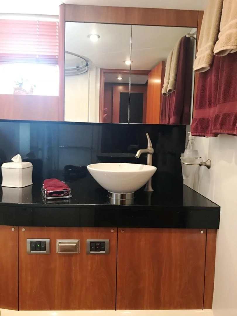 a bathroom with a sink and a mirror aboard DAY DREAMER Yacht for Sale