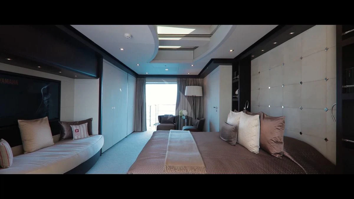 a room with a bed and a chair aboard PERSEFONI I Yacht for Sale