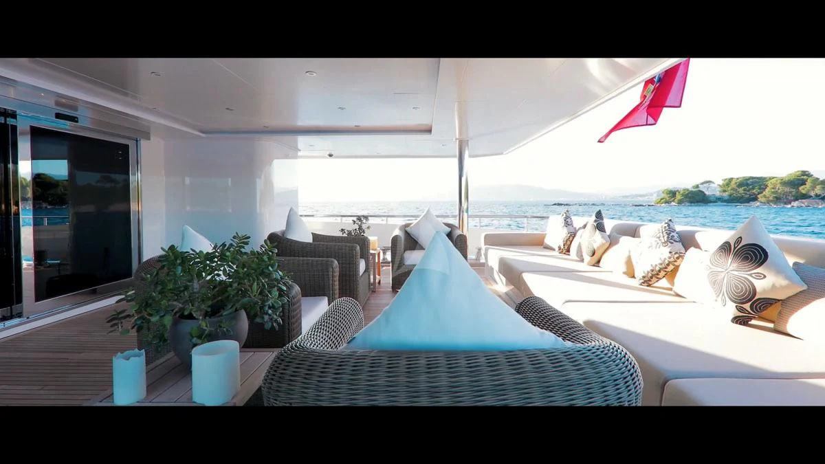 a room with a table and chairs and a flag aboard PERSEFONI I Yacht for Sale