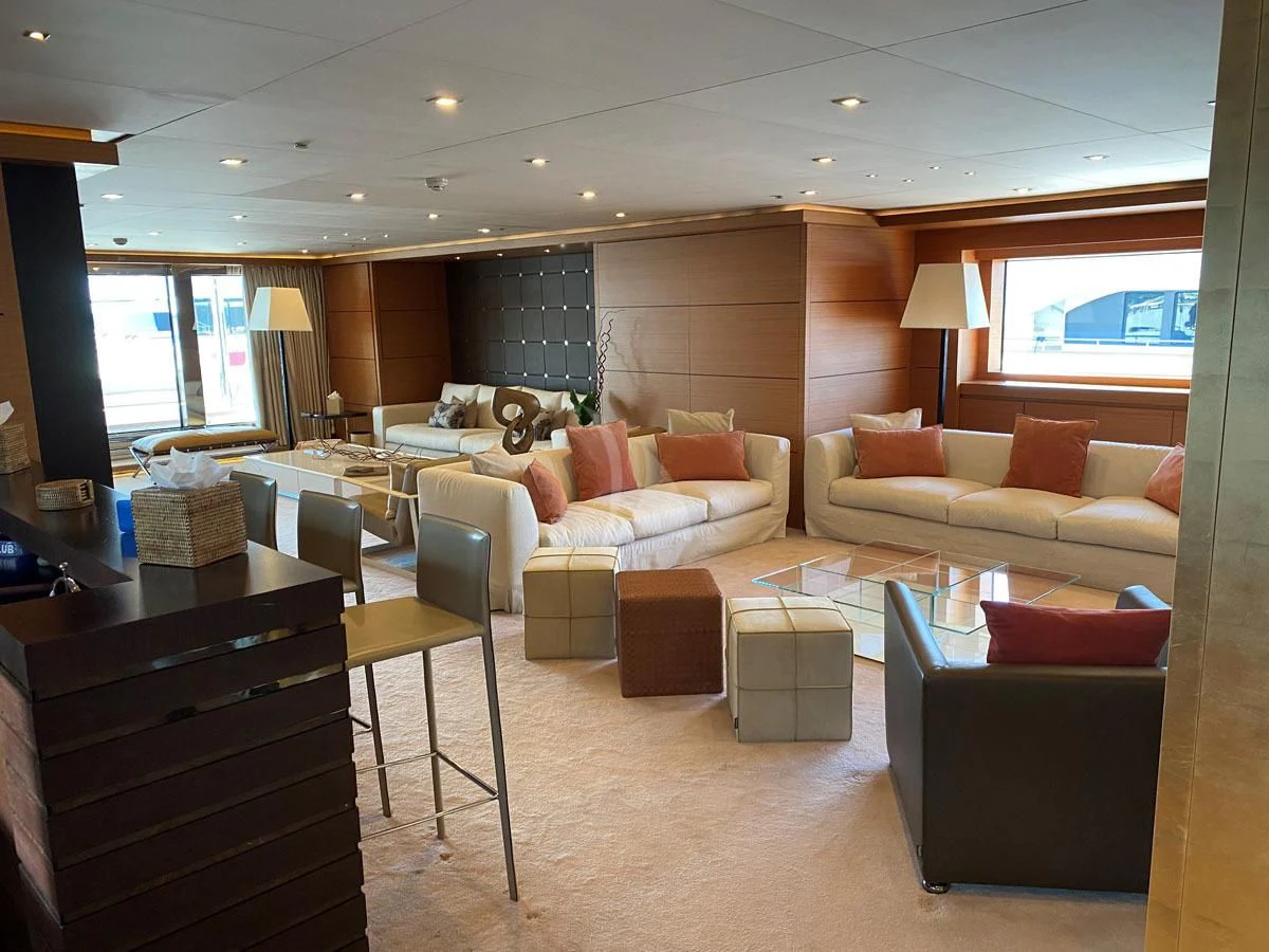 a living room with a couch and a table aboard PERSEFONI I Yacht for Sale