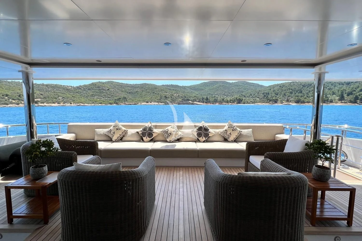 a large white couch sits in front of a large window aboard PERSEFONI I Yacht for Sale