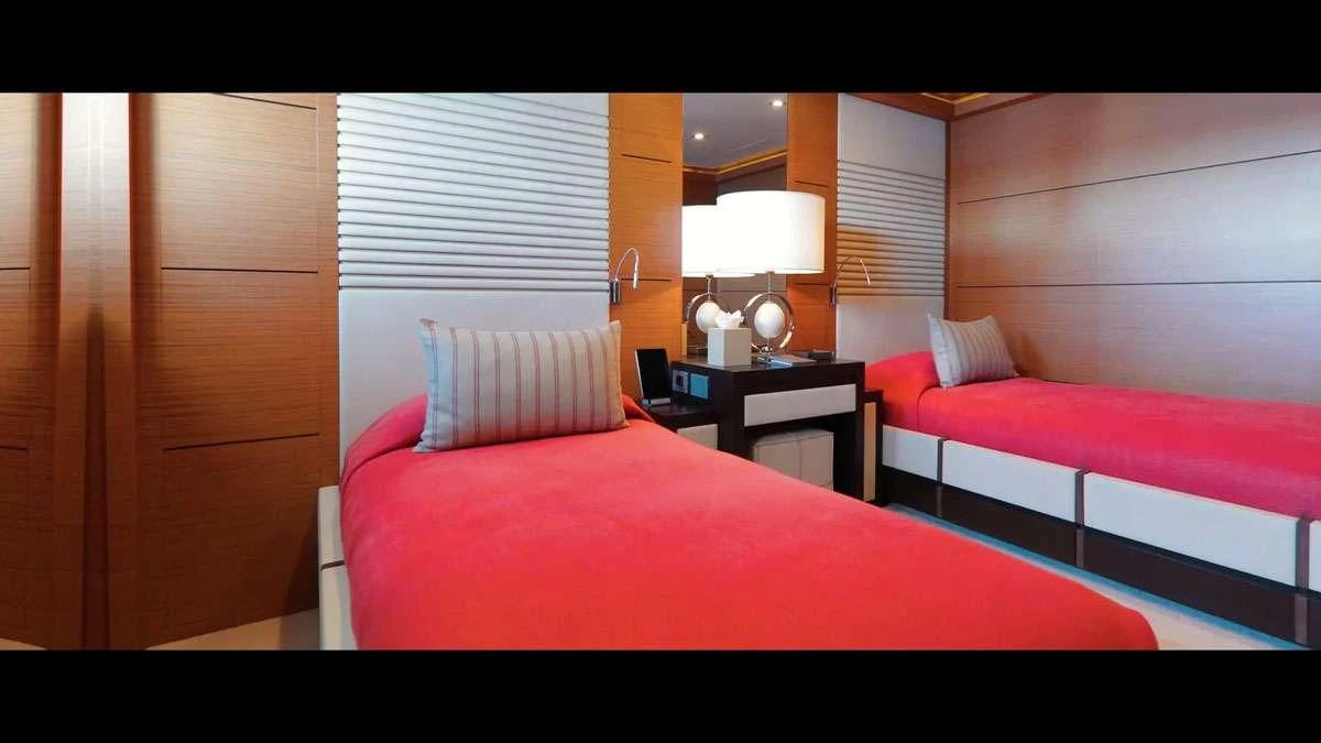 a room with a bed and a desk aboard PERSEFONI I Yacht for Sale