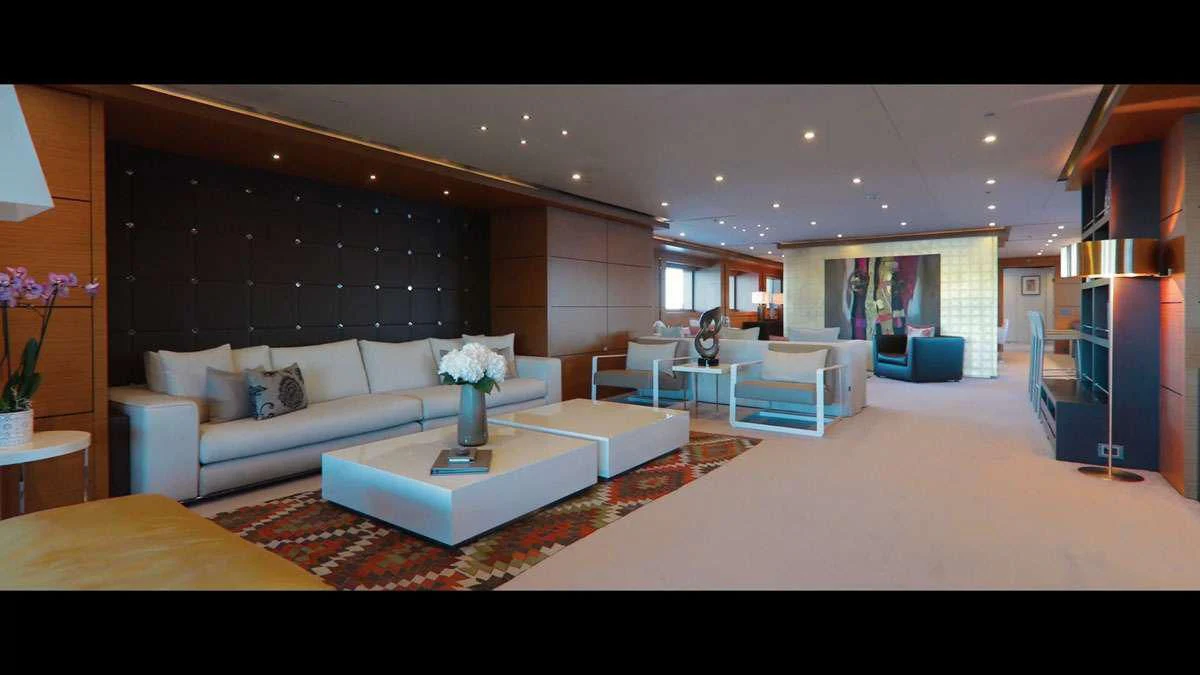 a living room with a large screen aboard PERSEFONI I Yacht for Sale