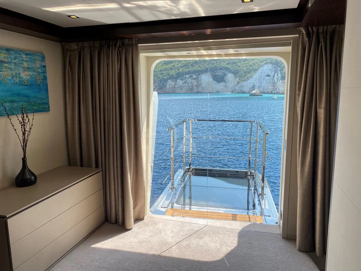 a room with a view of the ocean and a large window aboard PERSEFONI I Yacht for Sale