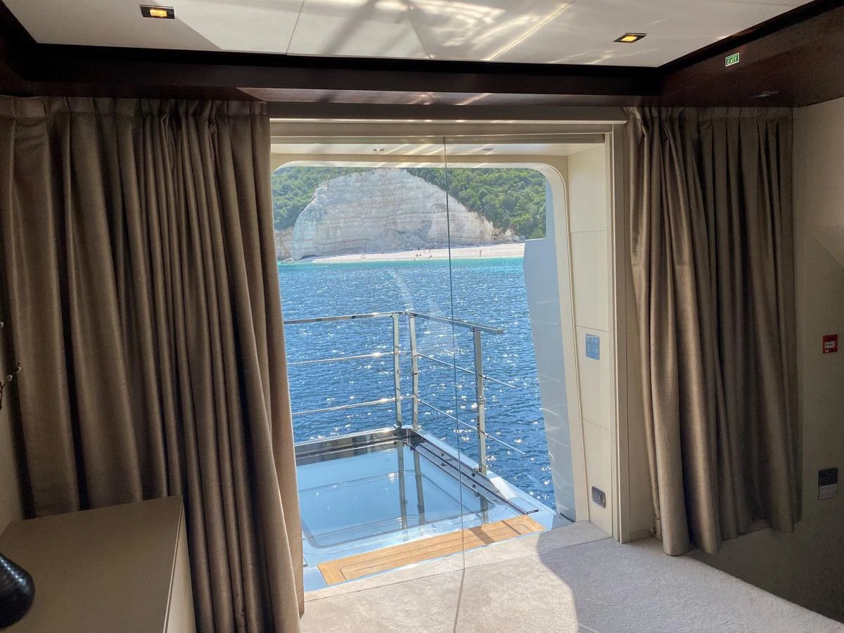 a room with a view of the water and the land below aboard PERSEFONI I Yacht for Sale
