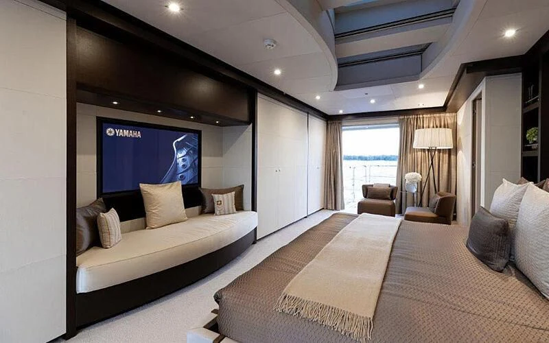 a hotel room with a bed and a large window aboard PERSEFONI I Yacht for Sale