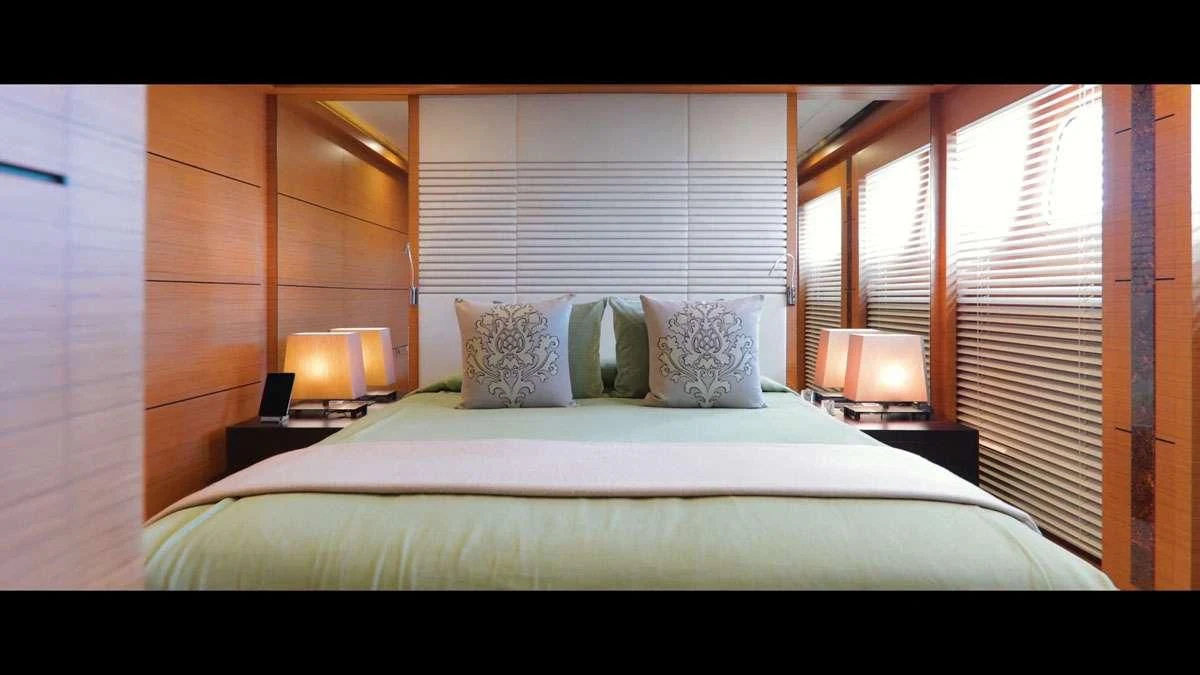 a bed with a white sheet and pillows aboard PERSEFONI I Yacht for Sale