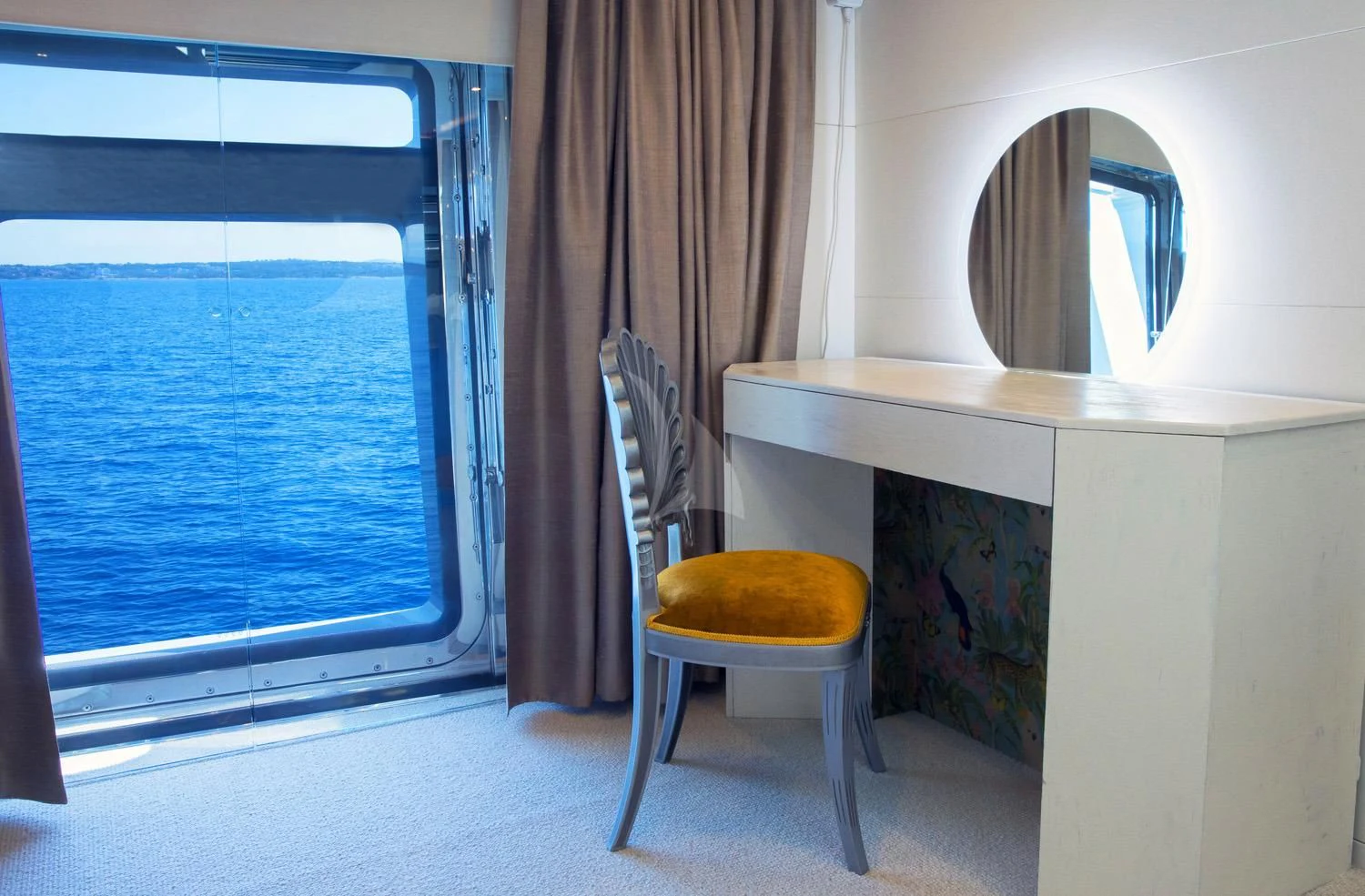 a chair next to a window aboard PERSEFONI I Yacht for Sale