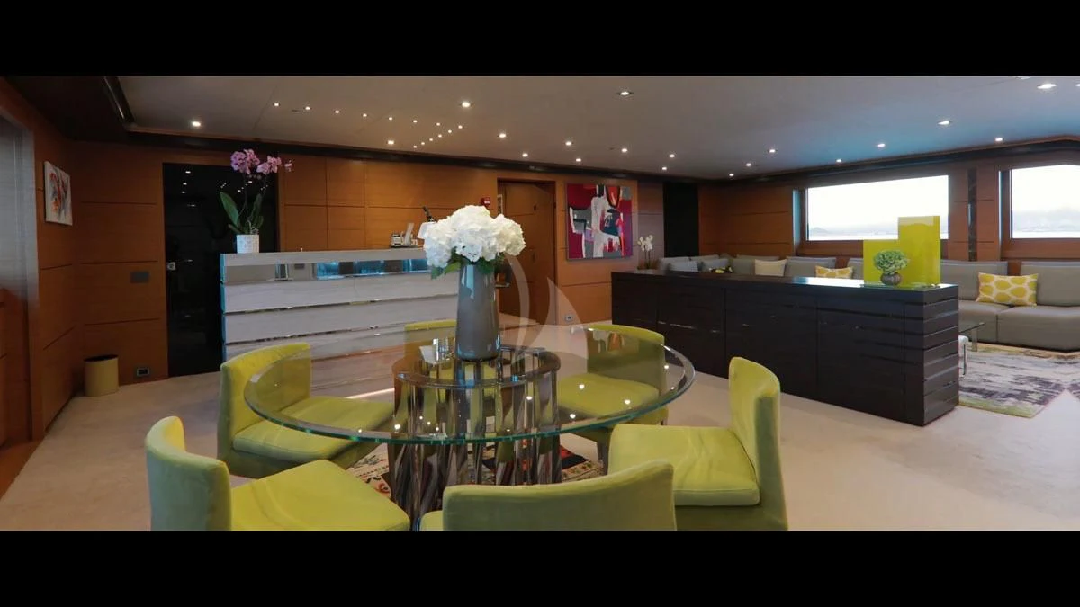 a kitchen with a table and chairs aboard PERSEFONI I Yacht for Sale
