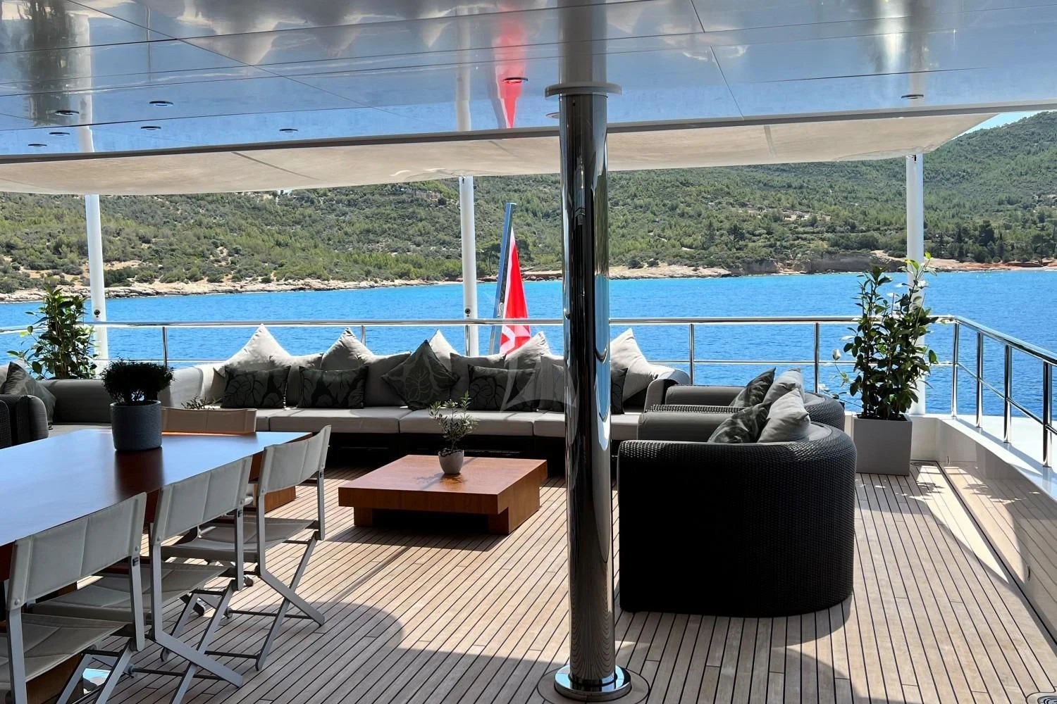 a deck with a couch and a table and chairs aboard PERSEFONI I Yacht for Sale