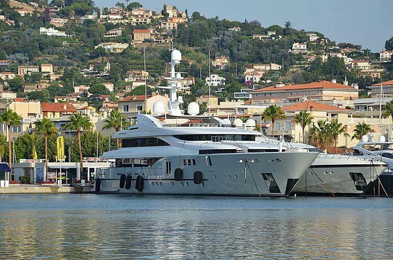 a large white boat in a harbor aboard PERSEFONI I Yacht for Sale