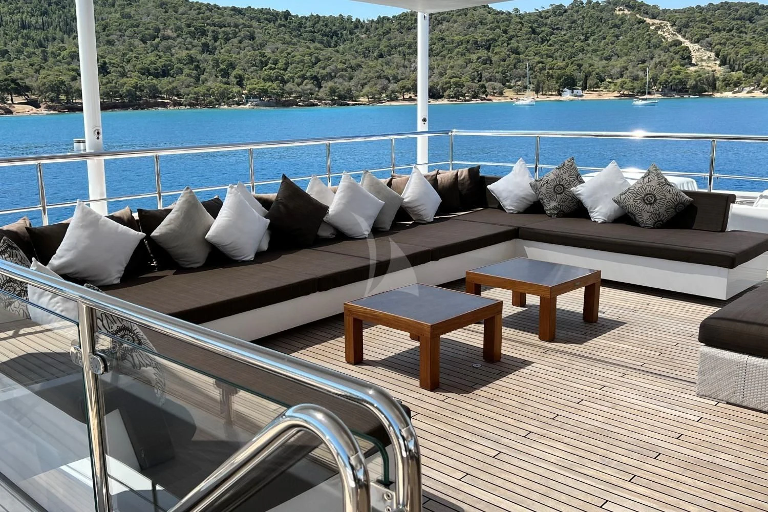 a deck with pillows and a table on it aboard PERSEFONI I Yacht for Sale