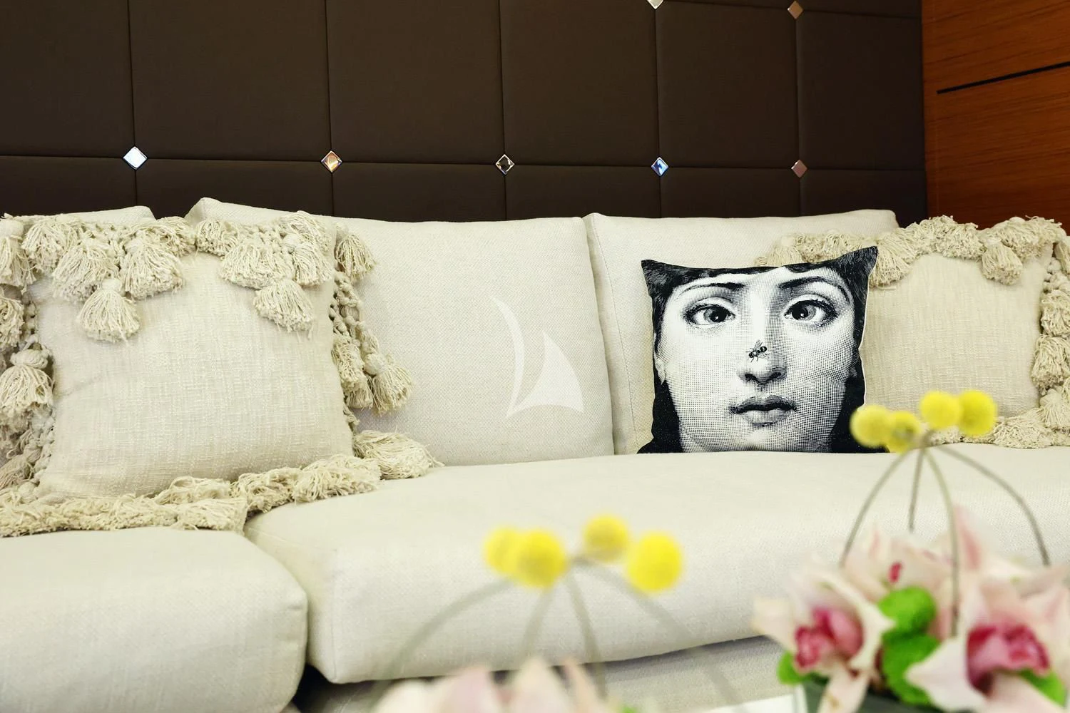 a couch with a white pillow and flowers on it aboard PERSEFONI I Yacht for Sale