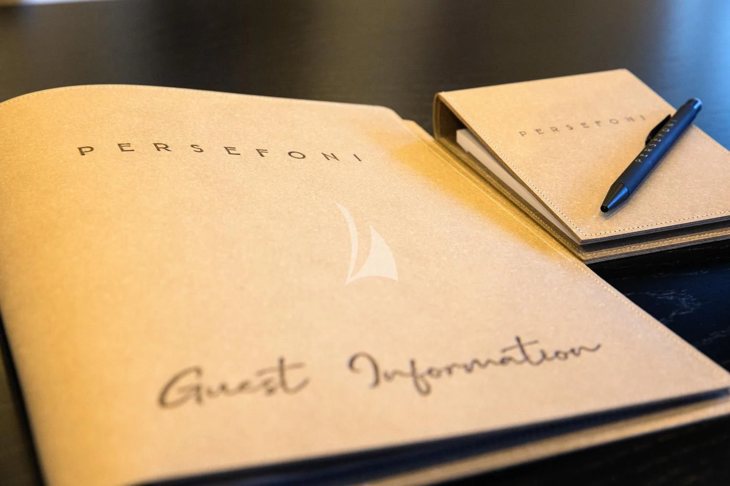 a notebook with a pen on it aboard PERSEFONI I Yacht for Sale
