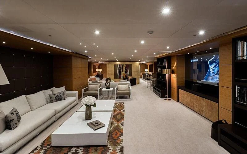a living room with a large screen aboard PERSEFONI I Yacht for Sale