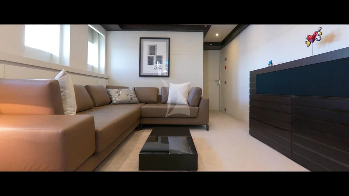 a living room with a couch and a coffee table aboard PERSEFONI I Yacht for Sale