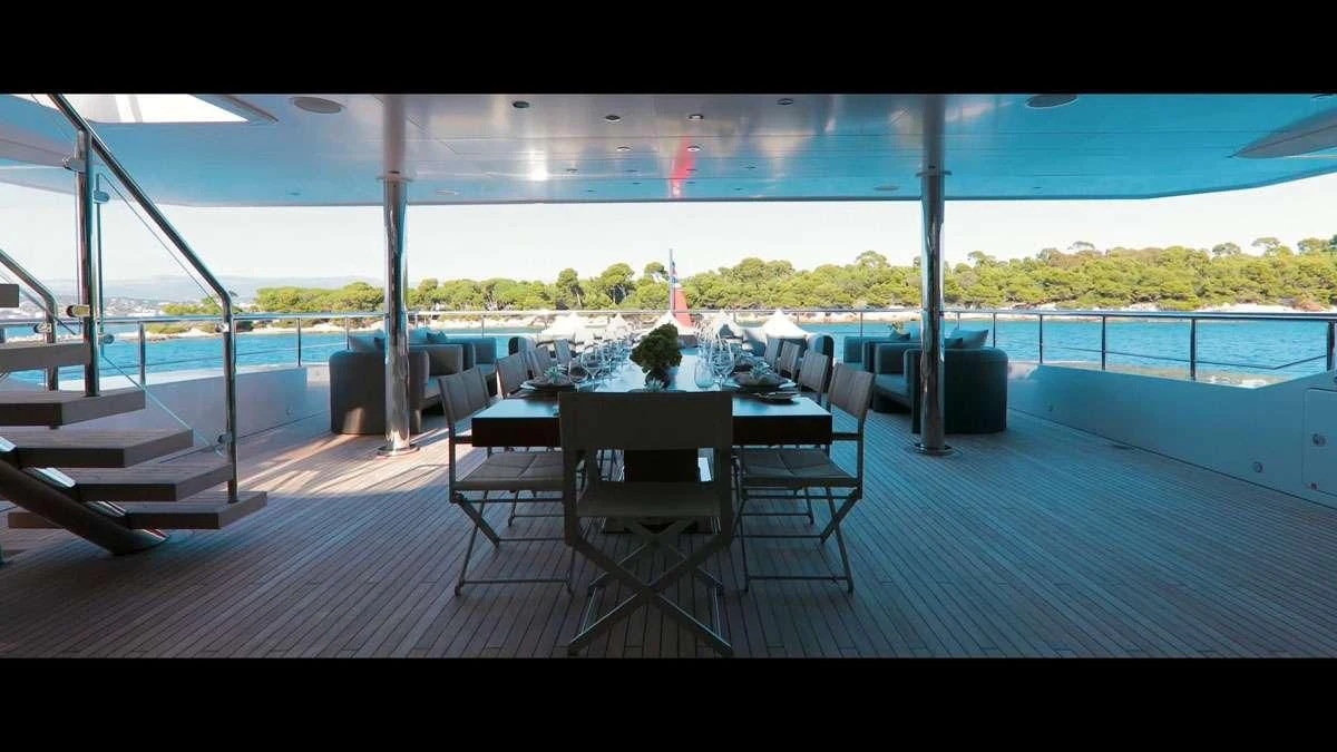 a deck with a table and chairs aboard PERSEFONI I Yacht for Sale