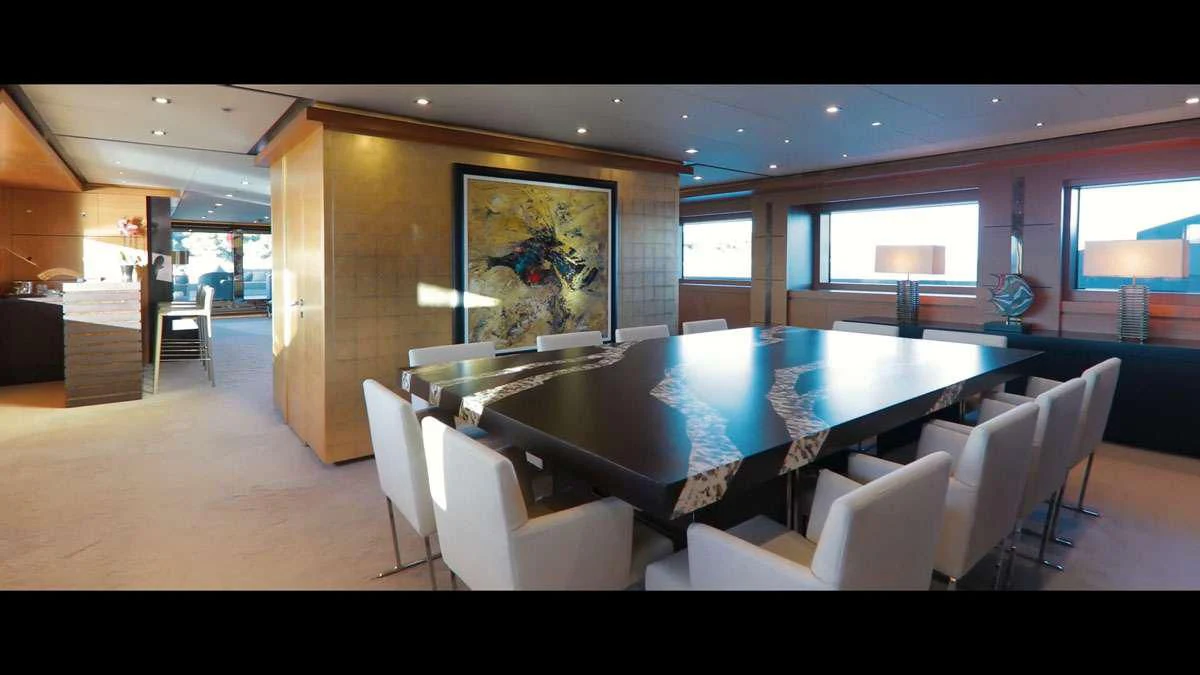 a large room with a table and chairs aboard PERSEFONI I Yacht for Sale