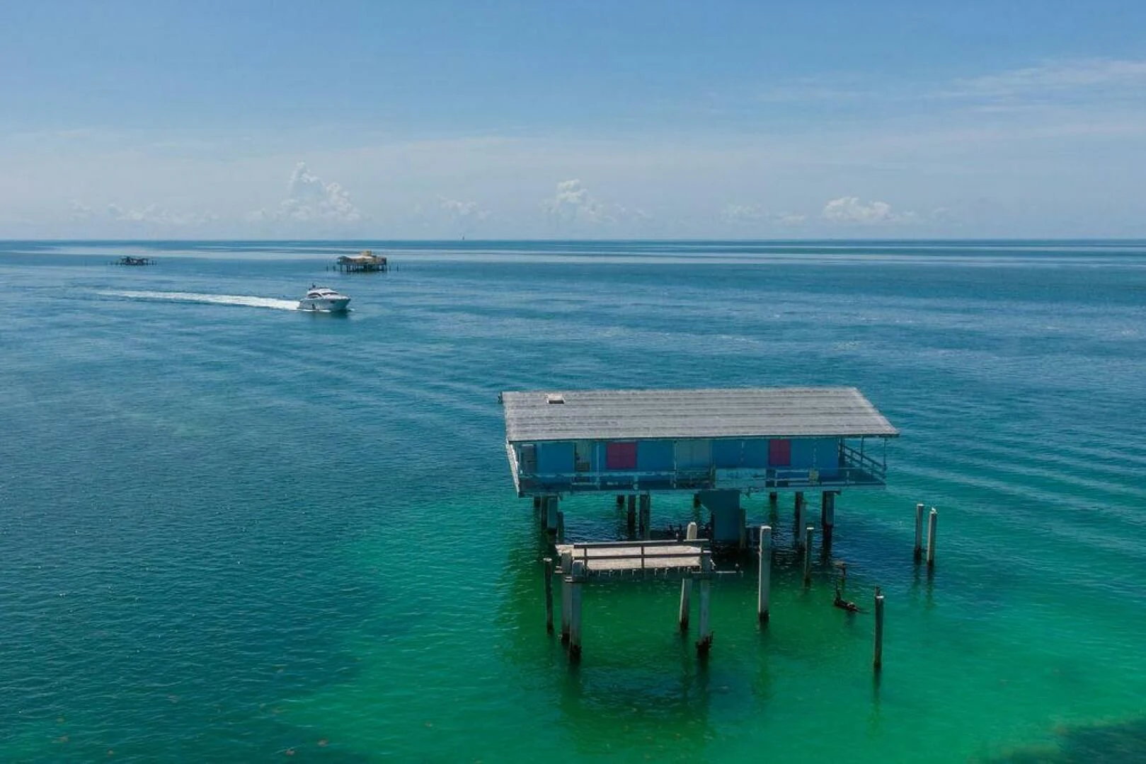 a house on a dock in the ocean aboard VIDI Yacht for Sale