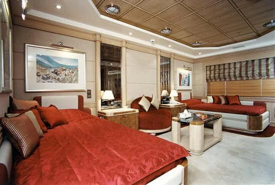 a large bed in a room aboard TUEQ Yacht for Sale