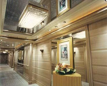 a room with a wood ceiling and a table with flowers on it aboard TUEQ Yacht for Sale