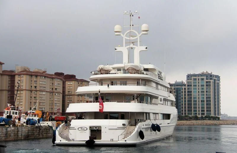 a large white boat in a harbor aboard TUEQ Yacht for Sale