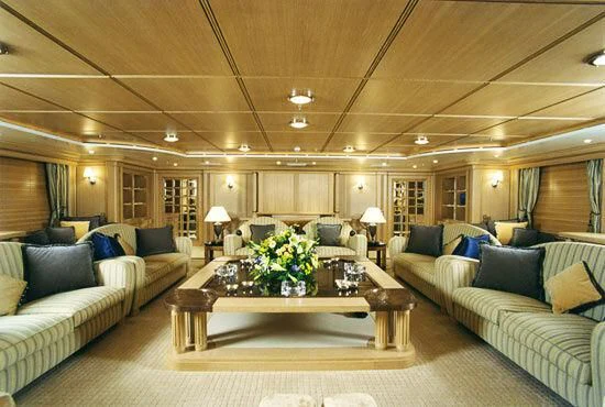 a living room with a large sofa and a coffee table aboard TUEQ Yacht for Sale