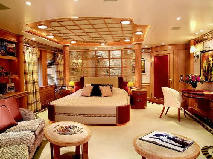 a large room with a bed and a table aboard TUEQ Yacht for Sale