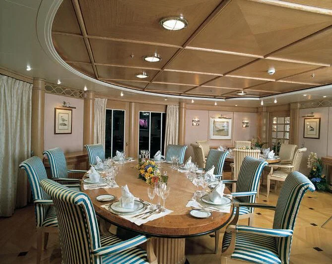 a dining room with a table and chairs aboard TUEQ Yacht for Sale