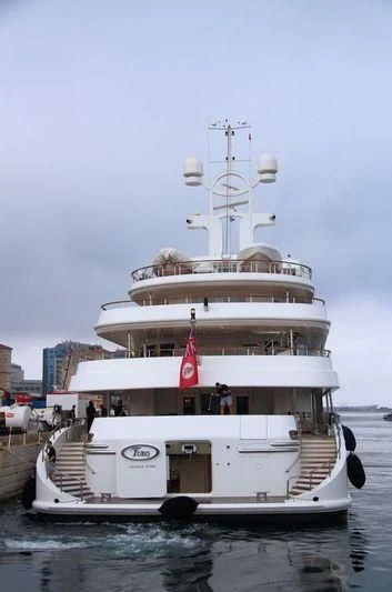 a large white boat with a flag on it aboard TUEQ Yacht for Sale