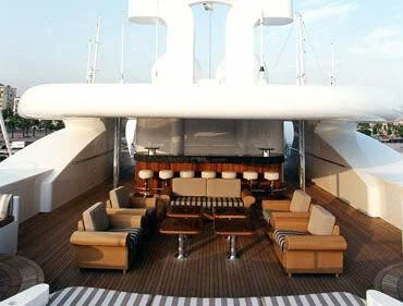 a room with a couch and a table and chairs aboard TUEQ Yacht for Sale