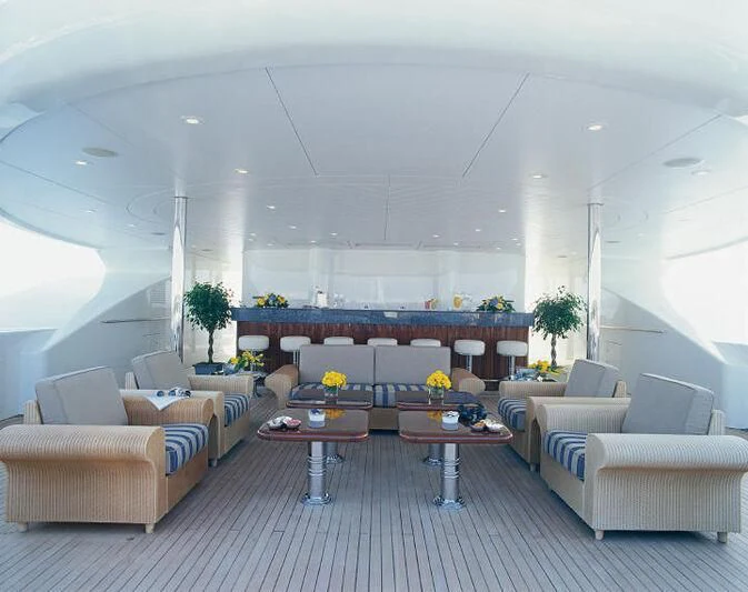 a living room with a large table aboard TUEQ Yacht for Sale