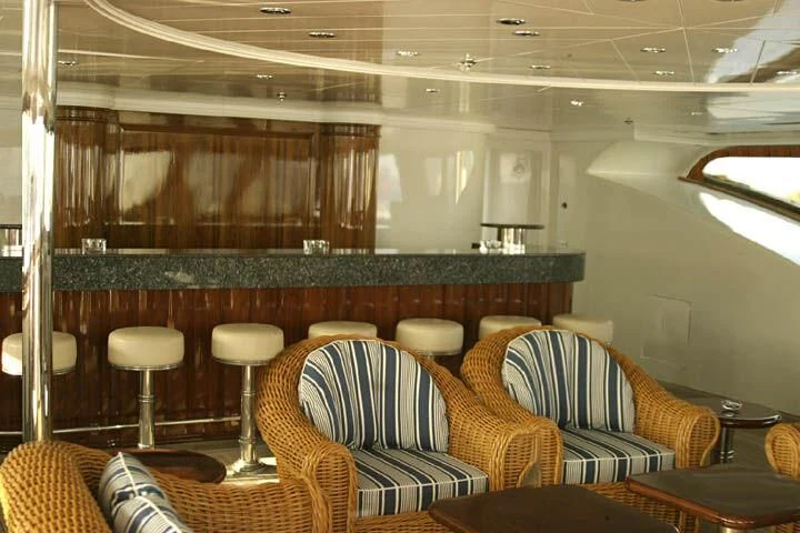 a room with chairs and a table aboard TUEQ Yacht for Sale