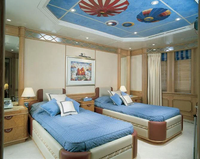 a bedroom with a bed and a fan aboard TUEQ Yacht for Sale