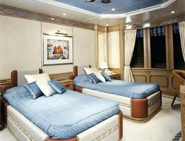 a room with a bed and a couch aboard TUEQ Yacht for Sale