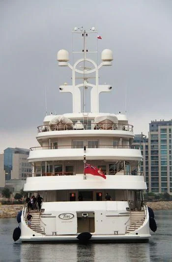 a large white boat with a flag on top aboard TUEQ Yacht for Sale