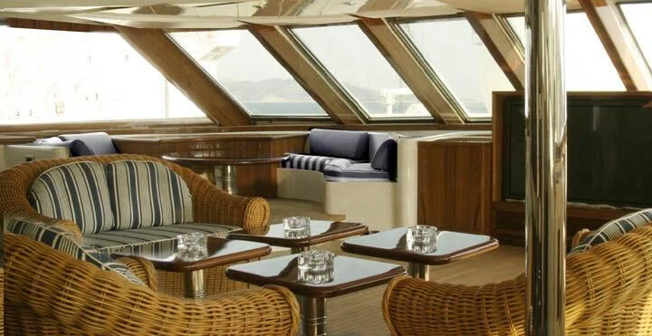 a room with a couch and a coffee table aboard TUEQ Yacht for Sale