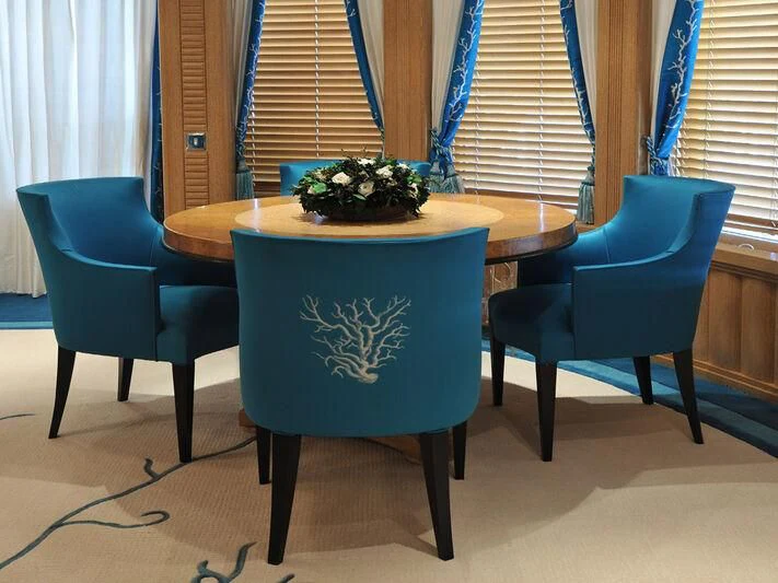 a table with chairs and a plant on it aboard TUEQ Yacht for Sale