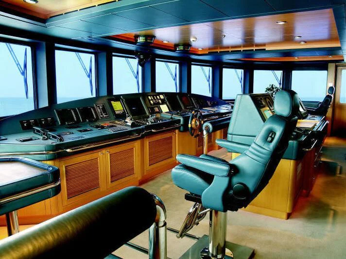 a room with a desk and chairs aboard TUEQ Yacht for Sale