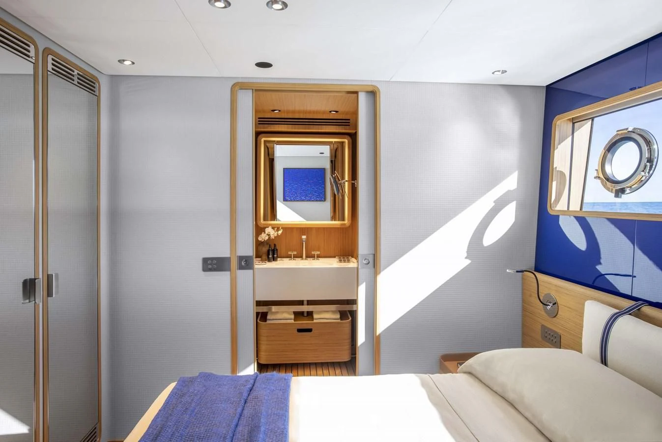 a room with a bed and a mirror aboard UPSTREAM Yacht for Sale