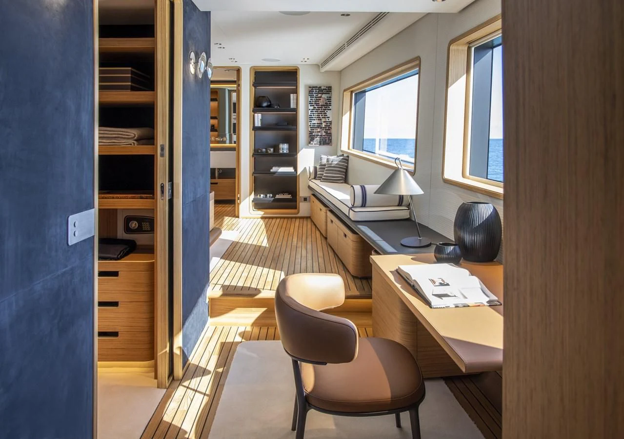 a room with a desk and a bed aboard UPSTREAM Yacht for Sale