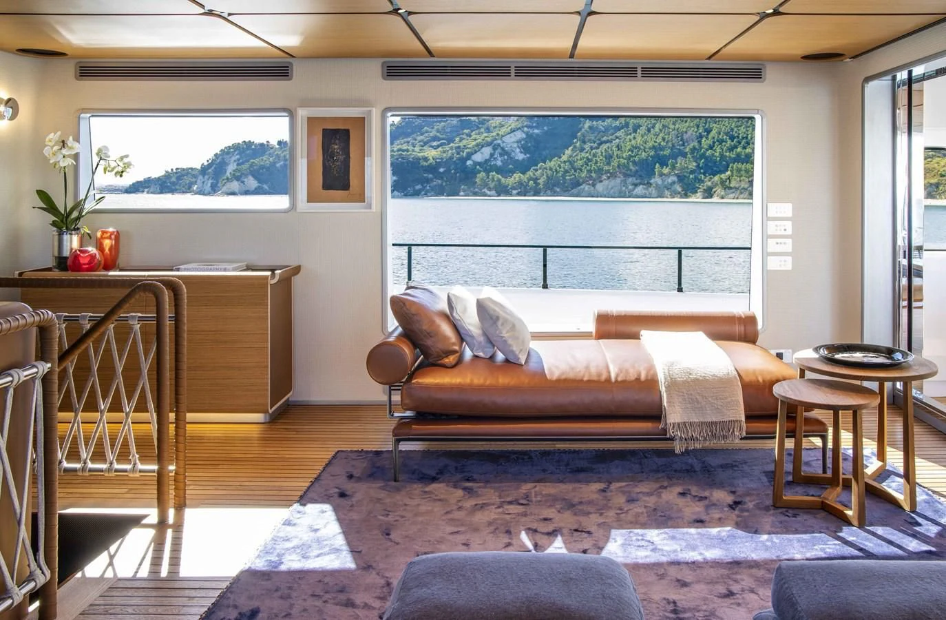 a living room with a couch and a table aboard UPSTREAM Yacht for Sale
