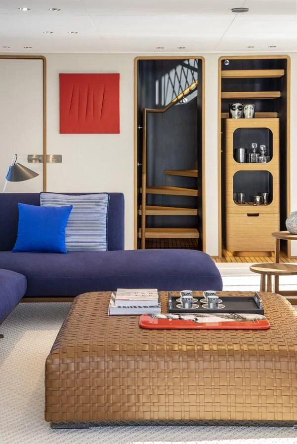 a living room with a couch and a table aboard UPSTREAM Yacht for Sale