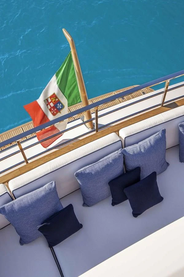 a deck with pillows and a flag aboard UPSTREAM Yacht for Sale