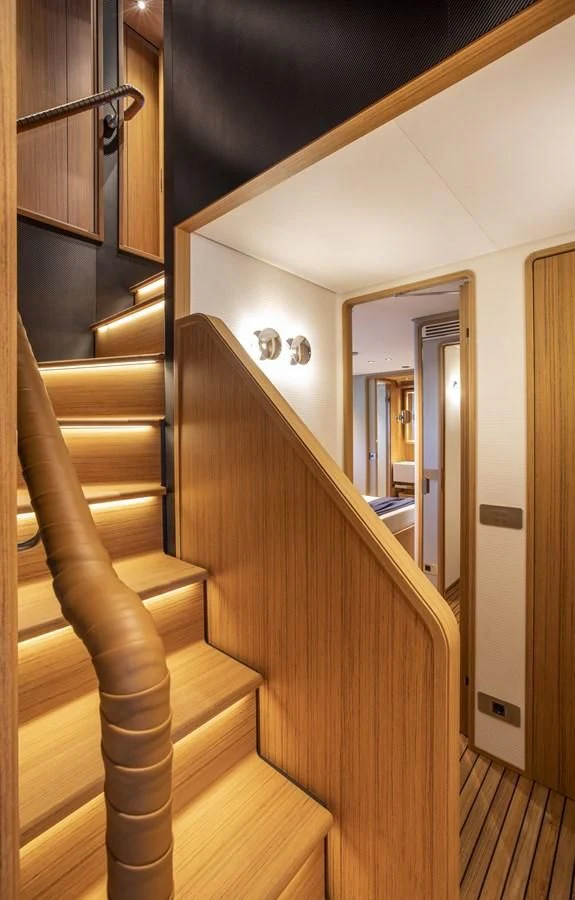 a wooden staircase in a house aboard UPSTREAM Yacht for Sale