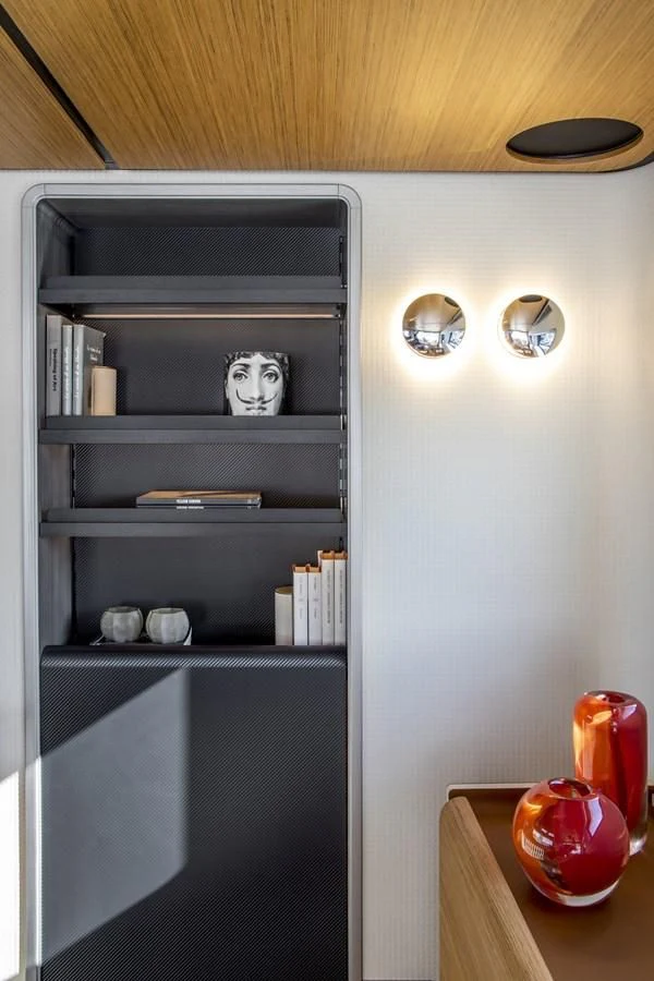 a white cabinet with a black door aboard UPSTREAM Yacht for Sale